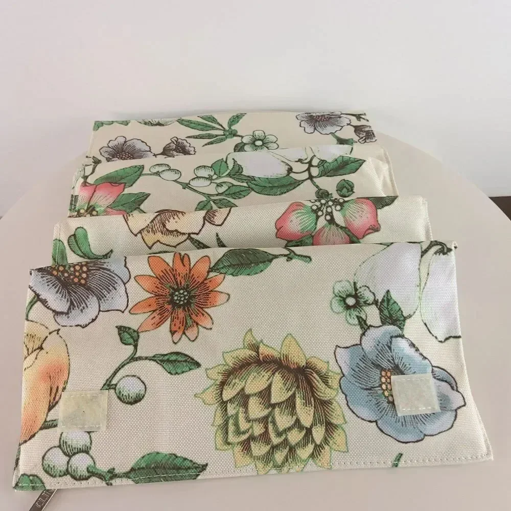 Clinique cream floral print fold over makeup / jewelry bag.
